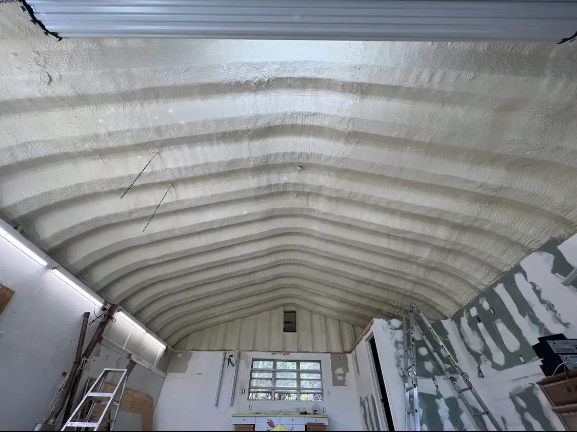 Spray polyurethane foam applied to the underside of a metal roof deck in Hoover
